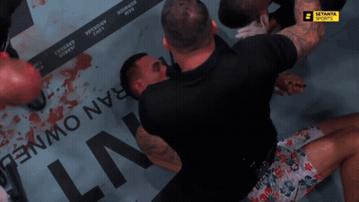 Man In UFC Shorts Lying On Ground GIF