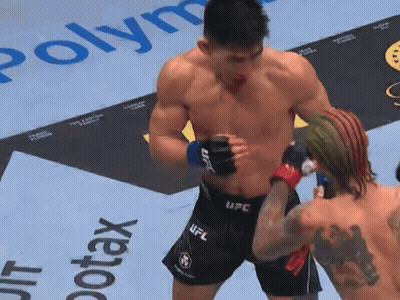 Man In UFC Shorts Next To Man In Boxing Ring GIF