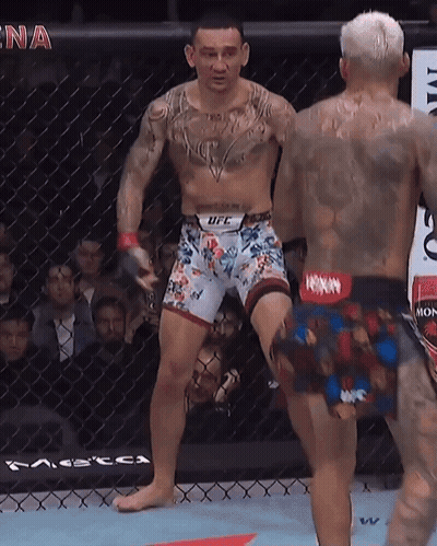 Man In UFC Shorts Next To Man In Boxing Ring GIF