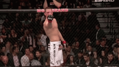 Man In UFC Shorts Standing In Crowd GIF