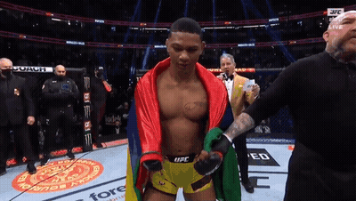 Man In UFC Shorts Standing On Stage GIF