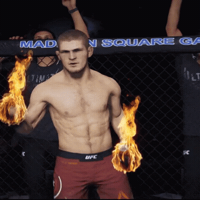 Man In UFC Shorts With Flames In Hands GIF