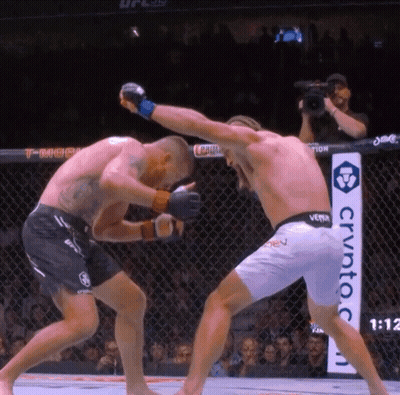 Man In UFC Uniform Helping Another Man GIF