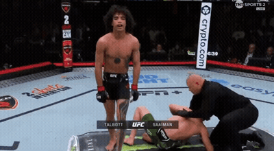 Man In UFC Uniform Stands Next To Another Man GIF