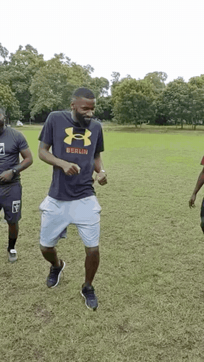Man In Under Armour Shirt Dancing In Field GIF