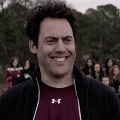 Man In Under Armour Shirt Smiling In Crowd GIF