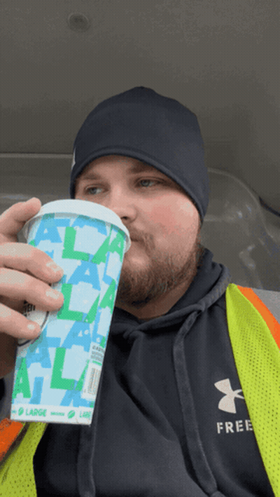 Man In Under Armour Vest Drinking Cup Saying Large GIF