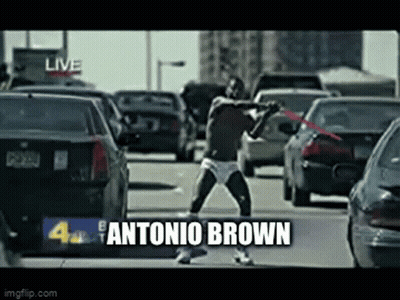 Man In Underwear Holding Red Sword On Busy Street GIF