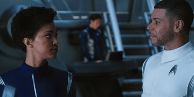 Man In Uniform With Letter A Standing Next To Woman GIF