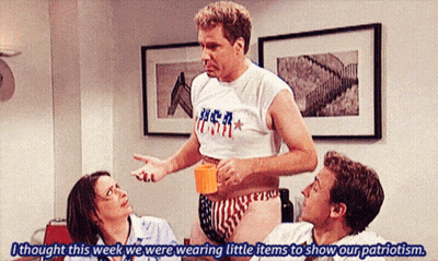 Man In USA Shirt Talking To Woman And Two Men GIF