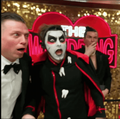 Man In Vampire Costume In Front Of Ring Sign GIF