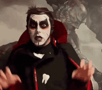 Man In Vampire Costume With Tooth Shirt GIF