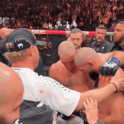 Man In Venom Hat Surrounded By Men GIF