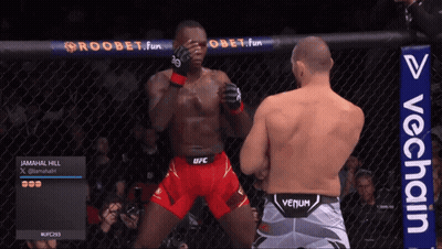 Man In Venum Shorts Next To Man In Red Shorts GIF