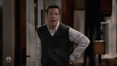 Man In Vest And Plaid Shirt Hands On Hips GIF