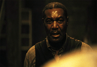Man In Vest And Shirt Looking At Camera GIF