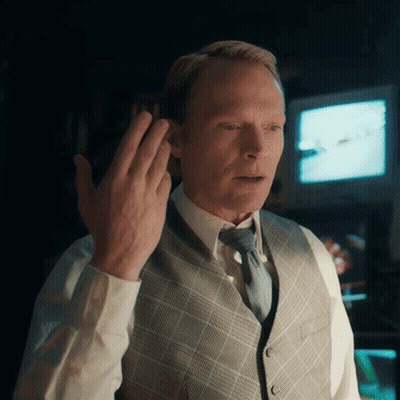 Man In Vest And Tie Holding Hand To Ear GIF