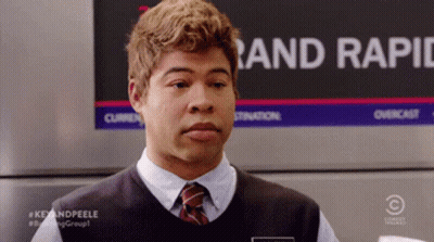 Man In Vest And Tie In Front Of Rand Rapid Sign GIF