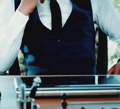 Man In Vest And Tie Sitting At Table GIF