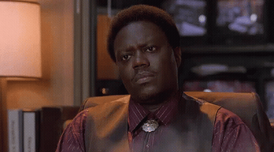 Man In Vest And Tie Sitting Before Television GIF