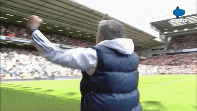 Man In Vest Arms Outstretched On Soccer Field GIF
