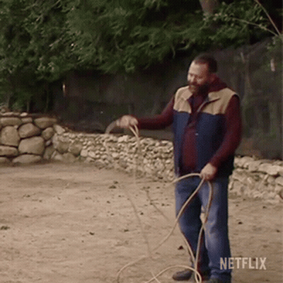 Man In Vest Holding Rope With Netflix Logo GIF