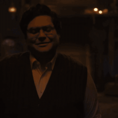 Man In Vest Looking Down GIF