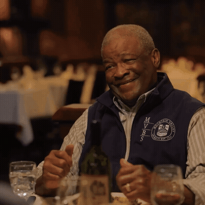Man In Vest Saying MVRS Sitting At Table GIF