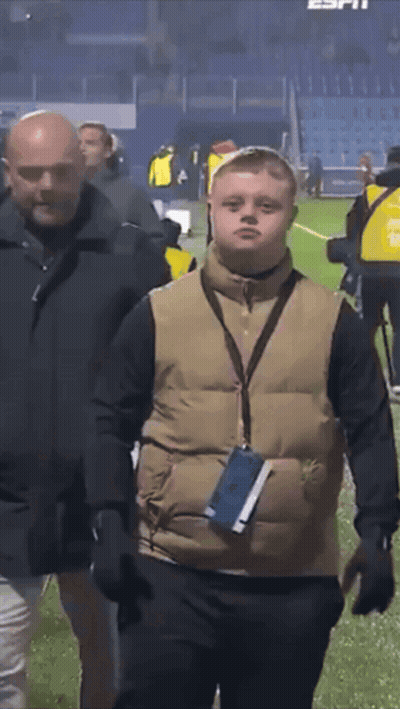 Man In Vest With Lanyard Walking On Field GIF
