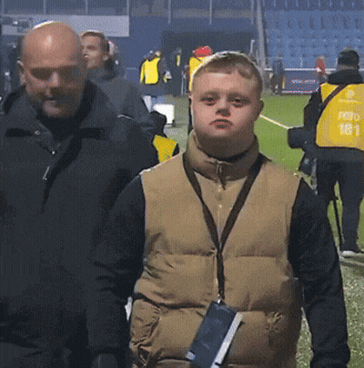 Man In Vest With Number 181 Next To Boy GIF