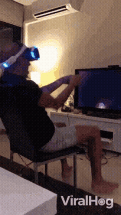 Man In VR Headset In Front Of TV GIF