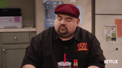 Man In W Shirt Sitting In Front Of Netflix Sign GIF