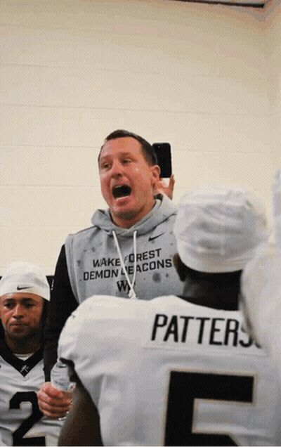 Man in Wake Forest Demon Deacons Sweatshirt Talks to Team