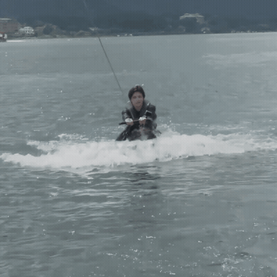 Man In Wetsuit Riding Wakeboard GIF