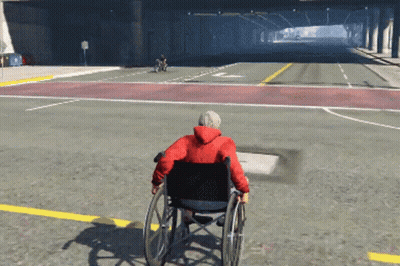 Man In Wheelchair Driving Down Street GIF