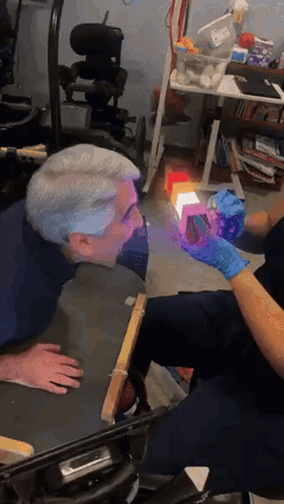 Man In Wheelchair Examined By Nurse With Gloves GIF