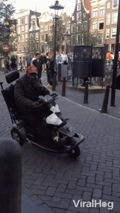 Man In Wheelchair Riding Mobility Scooter With Viralhog GIF