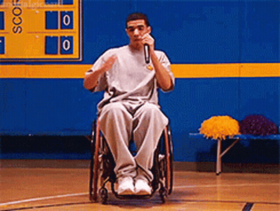 Man In Wheelchair Speaking Into Microphone GIF