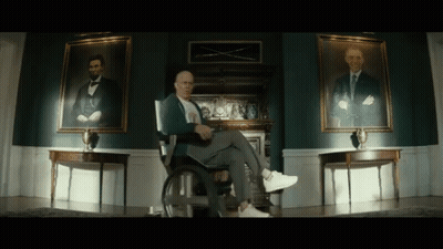 Man In Wheelchair With Two Abraham Lincoln Portraits GIF