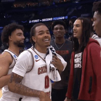 Man In Where More Begins Shirt Talking To Basketball Player GIF