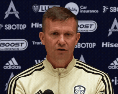 Man In White Adidas Jacket In Front Of Sbotop Banner GIF
