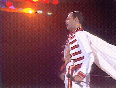 Man In White And Red Jacket Holding Microphone GIF