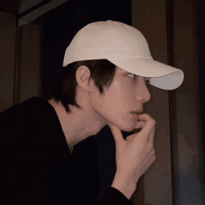 Man In White Baseball Cap Holding Hand To Face GIF