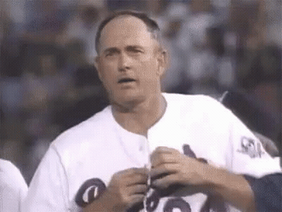 Man In White Baseball Uniform Holding Pen GIF