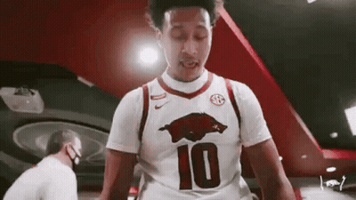 Man in White Basketball Jersey Number 10 in Gym