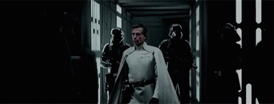 Man In White Cape Walking With Group GIF