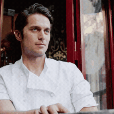 Man In White Chef Coat Sitting By Window GIF