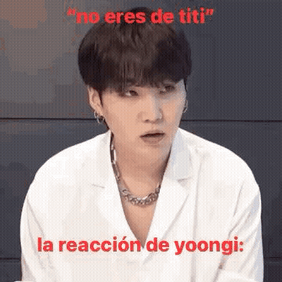 Man In White Coat And Necklace Making Funny Face Saying No Eres De Titi GIF