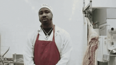 Man In White Coat And Red Apron With Meat GIF