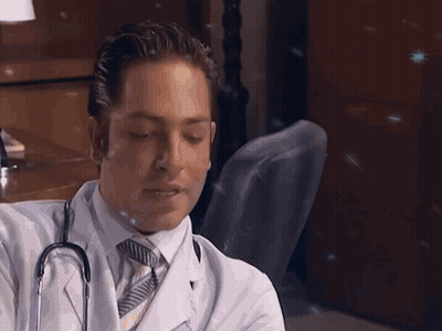 Man In White Coat And Tie Holding Stethoscope GIF